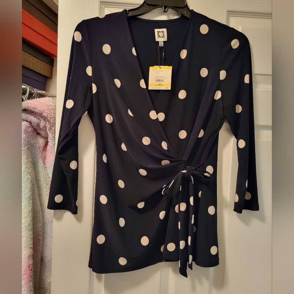 Black and white polka dot blouse with tie at waist.